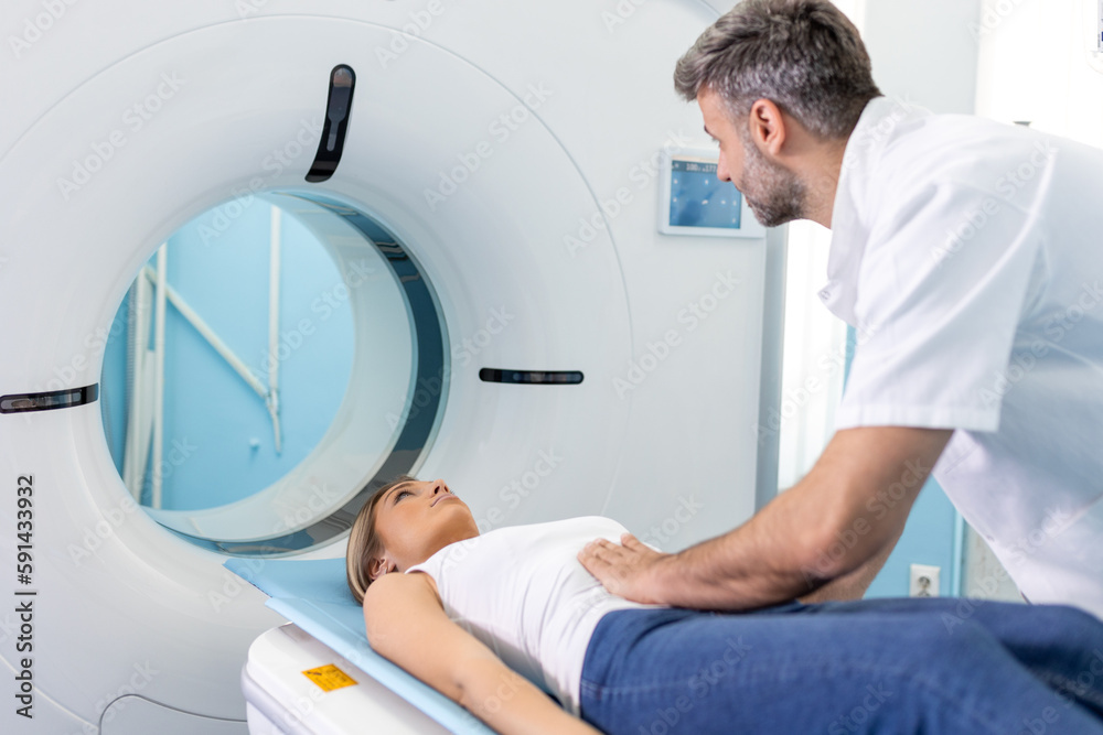 Medical equipment. Doctor and patient in the room of computed tomography at hospital. Doctor examining patient with CT scanner. Computerised tomography. Medical equipment. Doctor and patient in the room of computed tomography at hospital. Doctor examining patient with CT scanner. Computerised tomography.