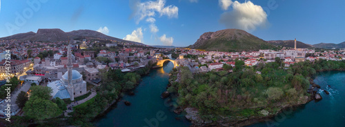 Fototapeta Naklejka Na Ścianę i Meble -  Aerial view of city of Mostar in Bosnia and Herzegovina and it's landmarks (Neretva river, Old bridge, Koski Mehmed Pasha Mosque).