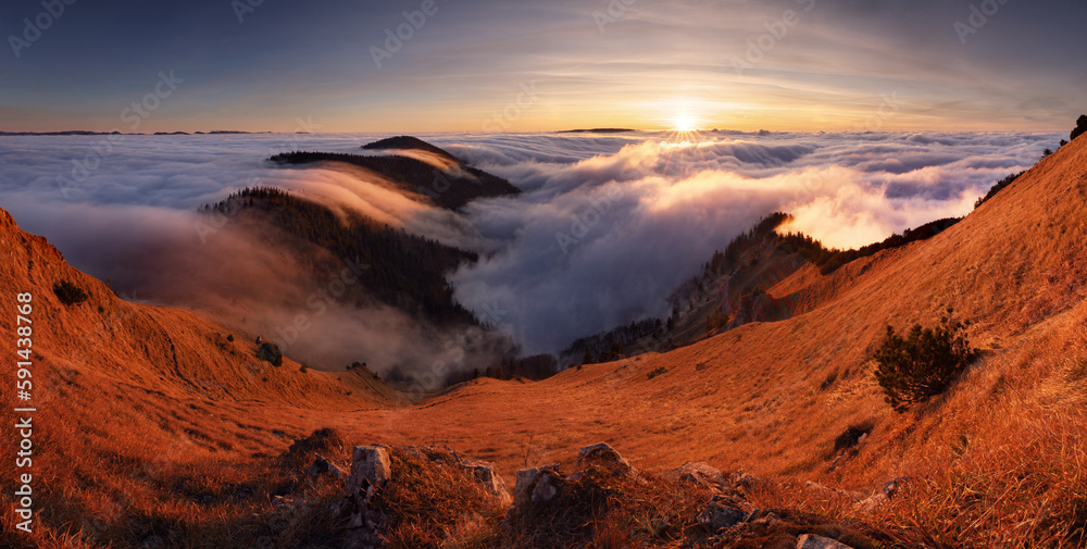 Dramatic sunrise in mountains with fog and sun  - landcape panorama