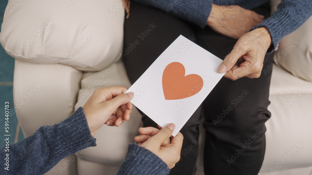 greeting card, Mother's day concept, young adult female daughter congratulate excited asian elderly mother at sofa with birthday anniversary, two generations family photo, real people. greeting card, Mother's day concept, young adult female daughter congratulate excited asian elderly mother at sofa with birthday anniversary, two generations family photo, real people.