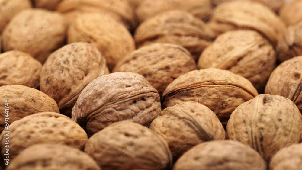 Walnut close up on a wooden table. Walnut close up. product rich in minerals and vitamins. Walnut turns in a shot. Walnut close up on a wooden table. Walnut close up. product rich in minerals and vitamins. Walnut turns in a shot.