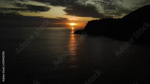 Aerial footage of Wangetti Beach running in a near-straight line from Slip Cliff Point at sunset photo