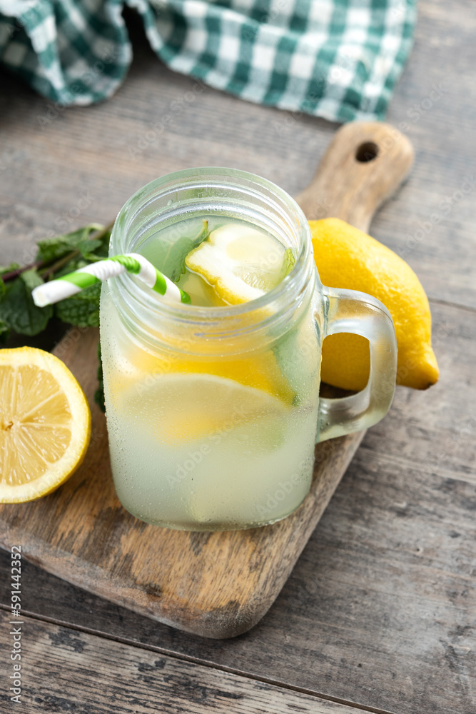 Lemonade drink in a jar glass and ingredients on wooden table Lemonade drink in a jar glass and ingredients on wooden table