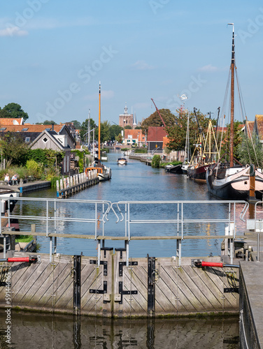 Diepe Dolte canal and church tower from lock in Workum, Friesland, Netherlands photo