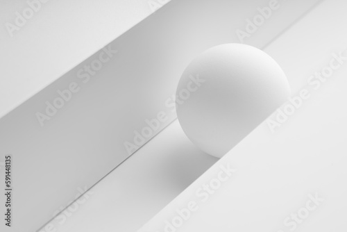 white sphere between paper background