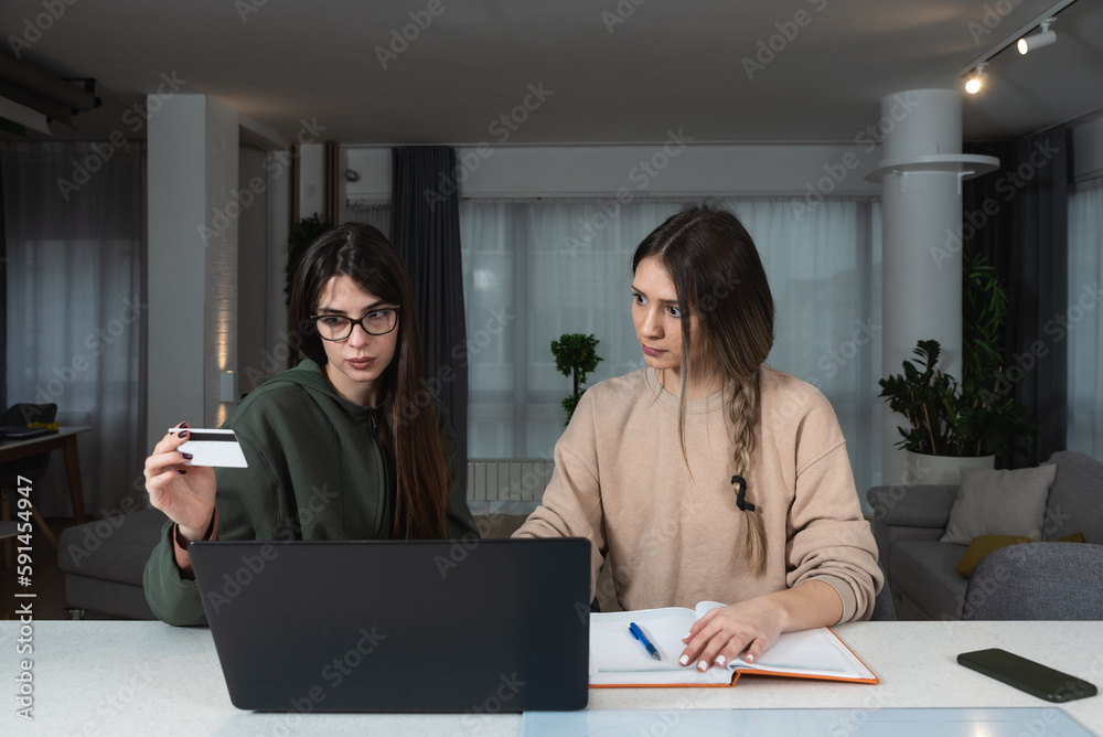 Two successful business woman working at home in office work space on laptop computer planning wedding or event for client. Small business owner female start up company internet online shopping expert Two successful business woman working at home in office work space on laptop computer planning wedding or event for client. Small business owner female start up company internet online shopping expert