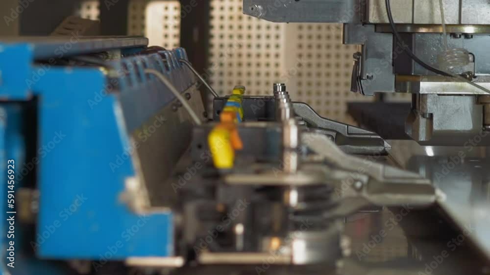 Manipulator carries large plastic sheet to punching machine cutter in plant workshop closeup. Production line technology at contemporary factory Manipulator carries large plastic sheet to punching machine cutter in plant workshop closeup. Production line technology at contemporary factory