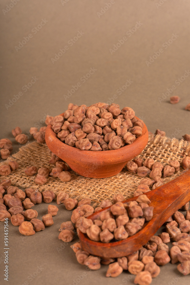 Black Chickpeas or Kala Chana with chana dal pulse isolated on wooden Background.