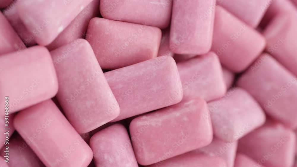 Pink Mint chewing gum close up, rotation. Vertical footage