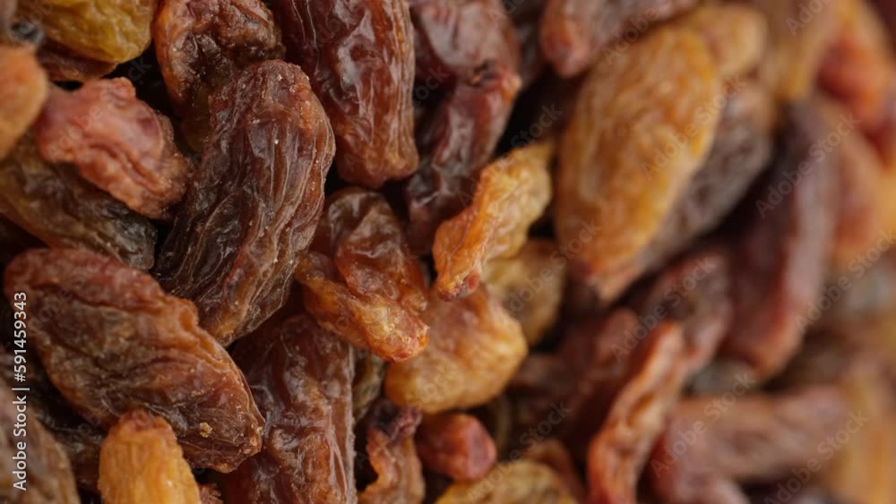 Raisin dried grape berries close up, rotation. Raisin ingredient in culinary cooking. Vertical footage Raisin dried grape berries close up, rotation. Raisin ingredient in culinary cooking. Vertical footage