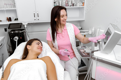 Cosmetology service,Rejuvenation treatment,Skin enhancement service,Cosmetologist consults with the client during the procedure