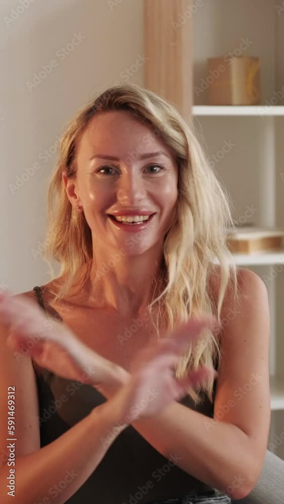 Vertical video. Refusal gesture. Protesting woman. No way. Smiling blonde lady gesturing crossing forbidden hands sitting sofa light room interior.