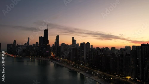 Sunset lakeshore moment during wintertime Chicago. Iconic city of chicago skyline. photo