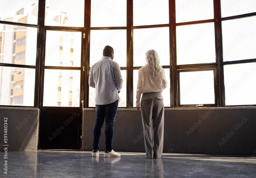 Diverse Business Man And Woman Talking Near Window In Office Diverse Business Man And Woman Talking Near Window In Office