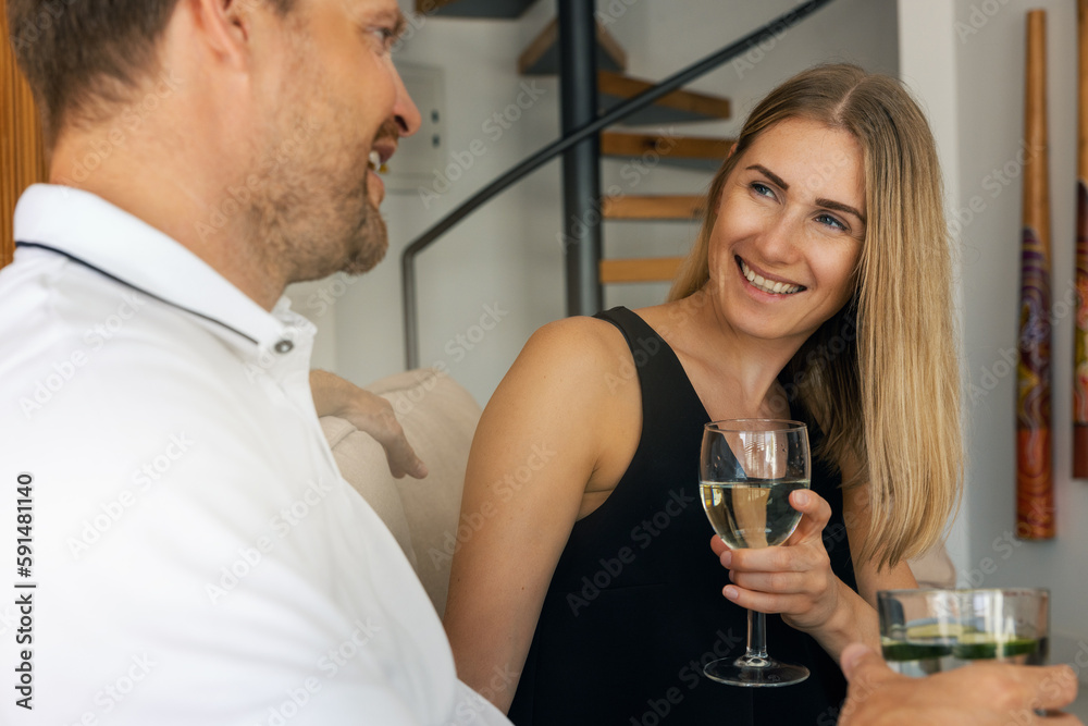 smiling young couple dating and drinking wine at home