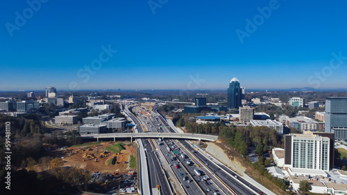 Canvas Print Construction site with heavy machines working along busy Interstate 285 highway,