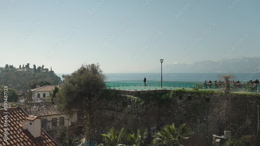 restaurant and observation deck on the roof of an old building against the backdrop of the sea and mountains. restaurant and observation deck on the roof of an old building against the backdrop of the sea and mountains.