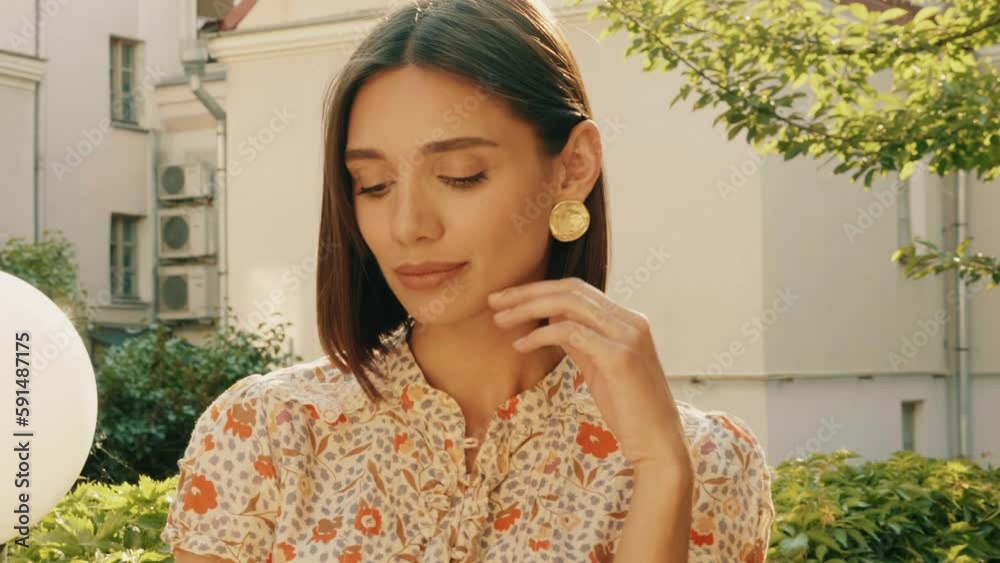 Portrait of young beautiful smiling  woman in trendy summer sundress. Sexy carefree woman posing on the street background at sunset. Positive model outdoors in the garden