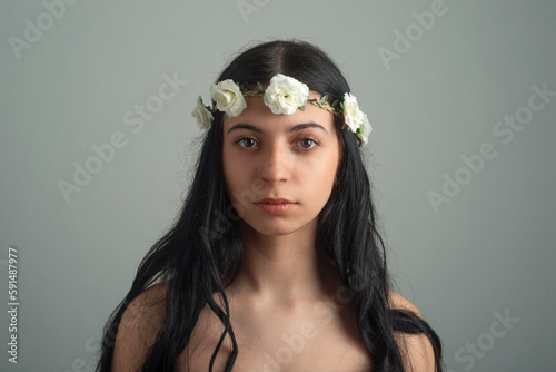 Beautiful young woman with flower wreath in her hair.Studio shot