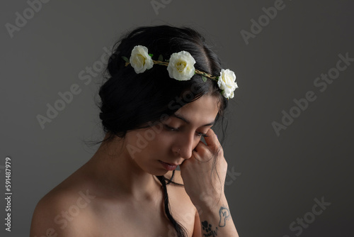 Portrait of young woman wearing floral crown.Studio shot