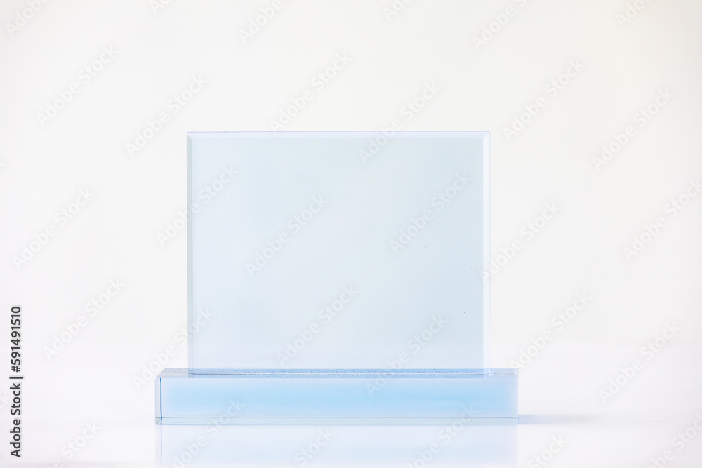 The shot of the blank transparent glass award trophy on a white background, the custom laser cut of the transparent crystal prize. The shot of the blank transparent glass award trophy on a white background, the custom laser cut of the transparent crystal prize.