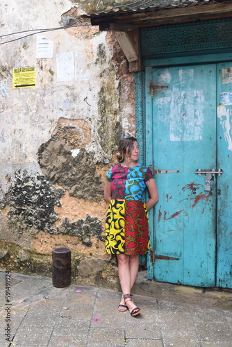 Girl poses with vintage door in Stone Town Zanzibar