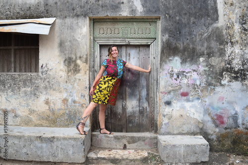 Girl poses with vintage door in Stone Town Zanzibar