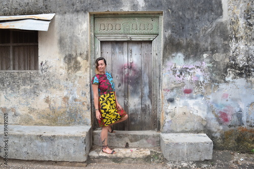 Girl poses with vintage door in Stone Town Zanzibar