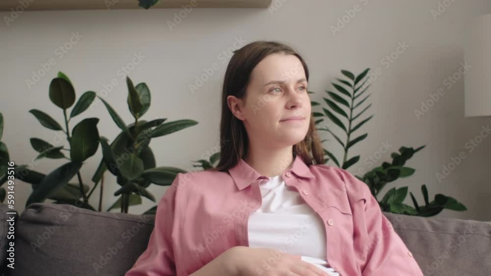 Smiling young caucasian pregnant woman using mobile phone while resting on comfortable couch in living room, checking baby clothes online, copy space. Pretty expecting lady with smartphone at home Smiling young caucasian pregnant woman using mobile phone while resting on comfortable couch in living room, checking baby clothes online, copy space. Pretty expecting lady with smartphone at home