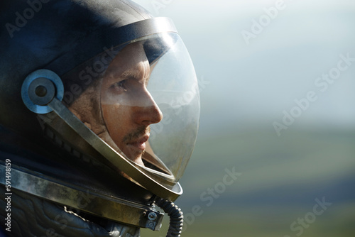 Thoughtful astronaut wearing space helmet photo