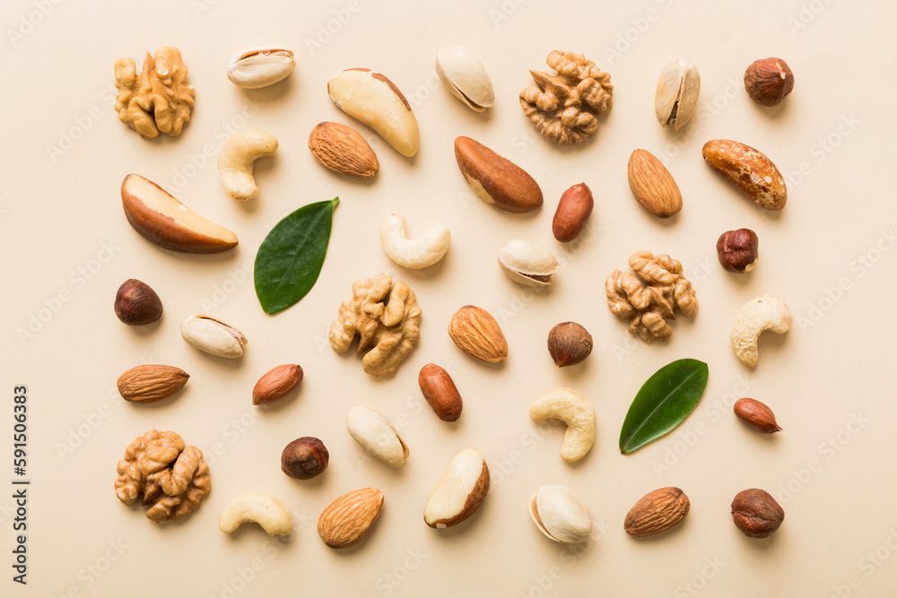 Composition of nuts , flat lay - mix hazelnuts, cashews, almonds on table background. healthy eating concepts and food background Composition of nuts , flat lay - mix hazelnuts, cashews, almonds on table background. healthy eating concepts and food background