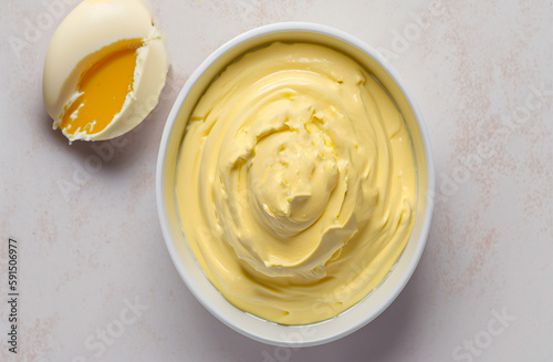 Homemade mayonnaise cooked with eggs and butter, top view, light background,