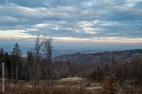 Landscape with mixed forest and colorful clouds at sunset. Early spring. View from Inovec hill, Slovakia.