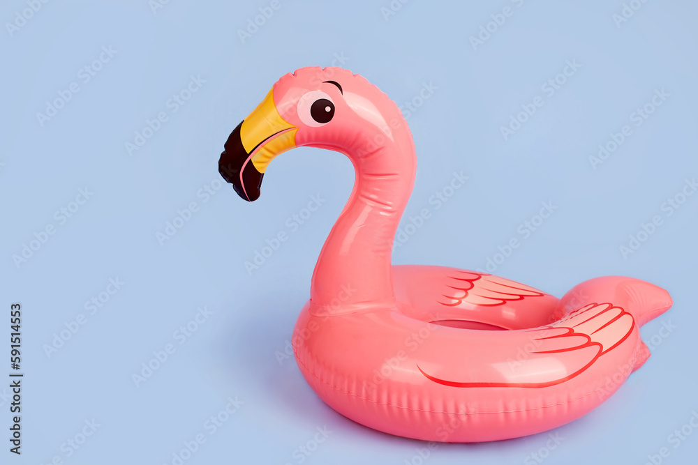 Inflatable flamingo on a blue background, a beach toy. Summer background with copy space. Inflatable flamingo on a blue background, a beach toy. Summer background with copy space.