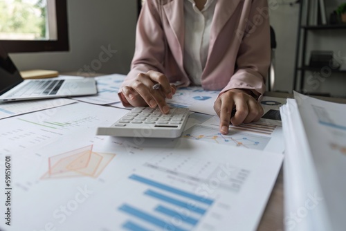 Bookkeeper using a calculator to calculate numbers on a company's financial documents, he is analyzing historical financial data to plan how to grow the company. Financial concept