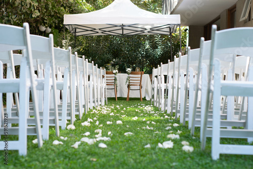 wedding setting with chairs and flowers petals 