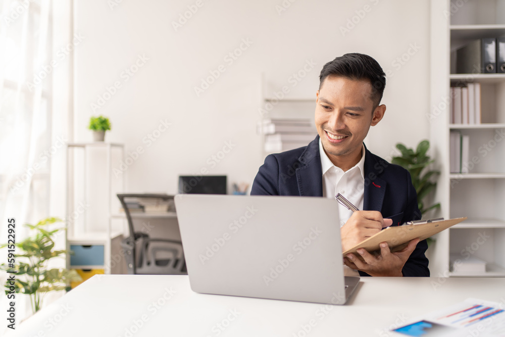 Young Asian Businesswomen smiling and happy used laptop working in the office. Young Asian Businesswomen smiling and happy used laptop working in the office.