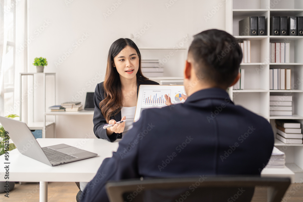 The couple of business talking about the project and make deal in the office. The couple of business talking about the project and make deal in the office.