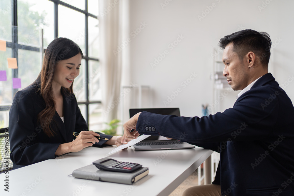 Young happy woman applying for job and giving she's CV to a manager during the interview and shakehand in the office. Young happy woman applying for job and giving she's CV to a manager during the interview and shakehand in the office.