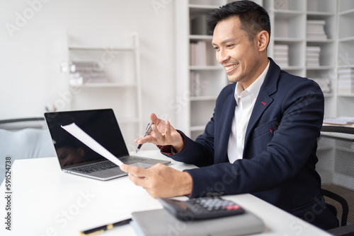 Close-up of a businessman shaking hands with a young Asian female, Work with document in the office.