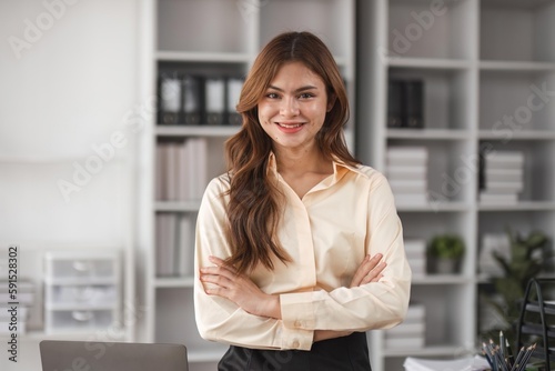 Portrait of successful confident pretty, Young asian business woman or freelancer wearing formal stylish clothes, arms crossed, looking at camera, smiling friendly