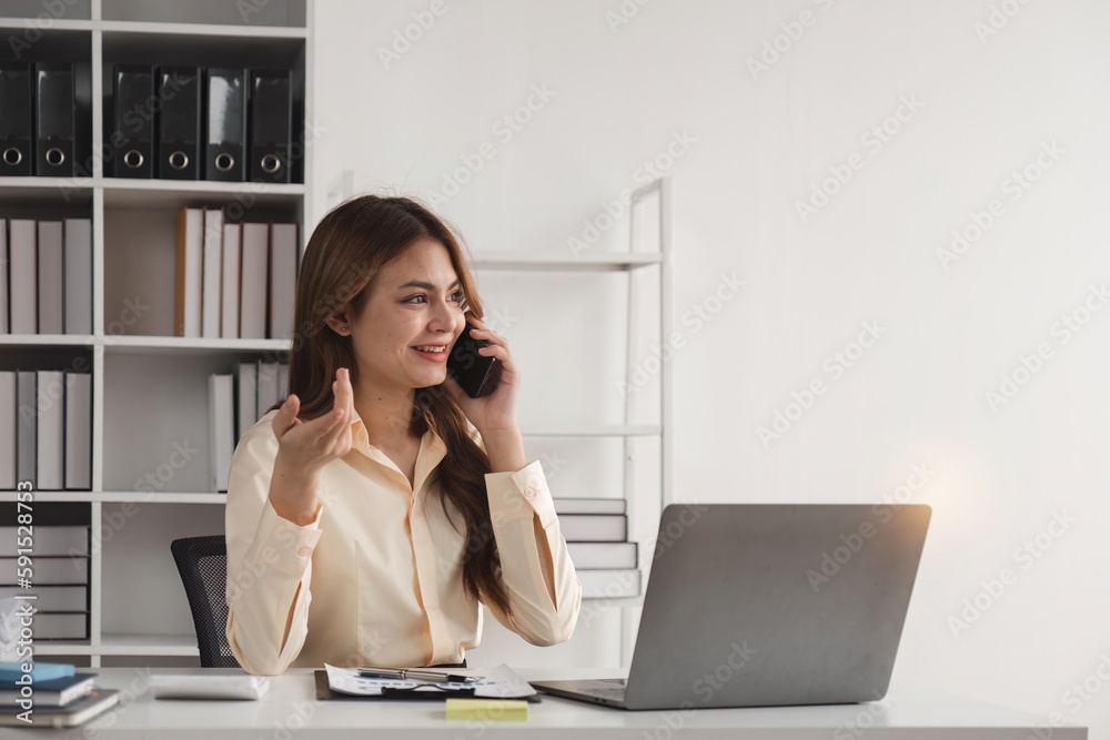 Business woman talking on a phone call in office. Happy female professional calling her associates on a mobile phone Business woman talking on a phone call in office. Happy female professional calling her associates on a mobile phone