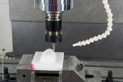 The  CNC milling machine cutting the nylon 6 material part with ball end mill tool. photo