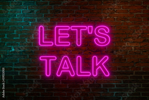 Let's talk. Neon sign. Brick wall at night with the text 