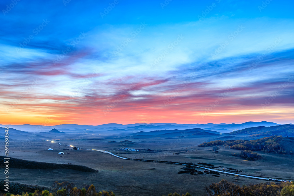 Beautiful mountain and colorful sky clouds landscape at sunrise in Inner Mongolia, China.