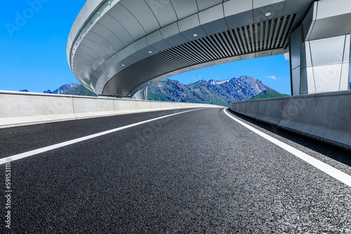 Asphalt road and bridge with mountain background