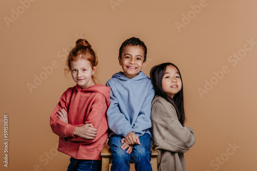 Portrait of three children, studio shoot. Concept of diversity in friendship.