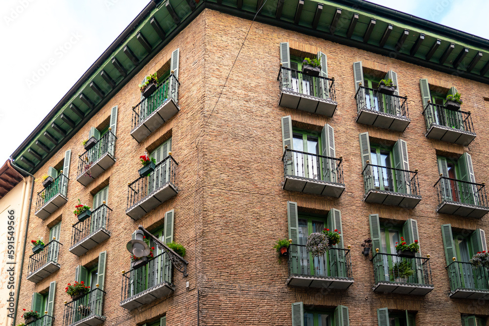 Fototapeta premium Pamplona, Navarra, SPAIN. The beautiful streets of the city of Pamplona. Beautifully coloured buildings with flowers of different colours, hanging from the balconies. Empty street, no peoples