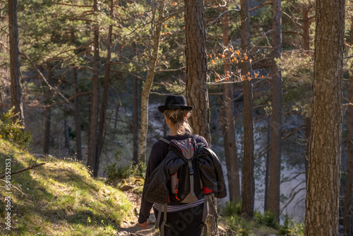traveler woman walking in nature, hiking in the forest. 