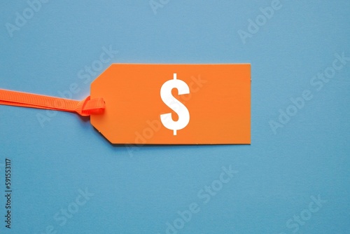 dollar symbol in orange price tag on blue background